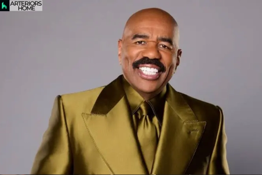 Steve Harvey smiling in a gold suit