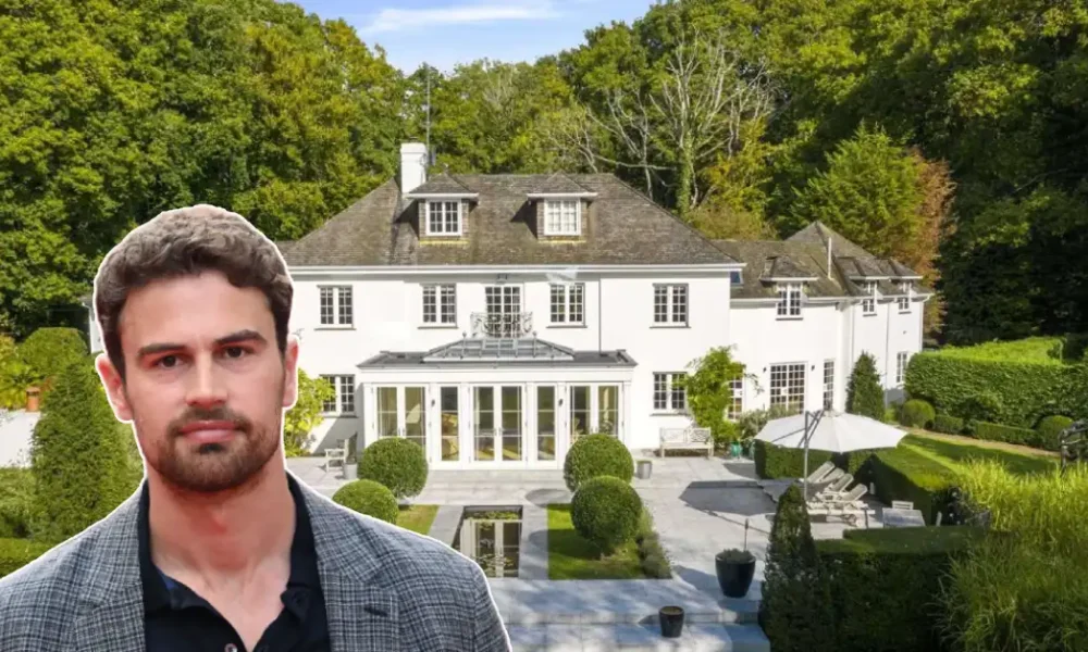 Theo James House: Actor Theo James stands before his grand white mansion, surrounded by lush gardens and elegant landscaping.