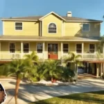 Kenan Thompson House with elegant waterfront views, palm trees, and a modern yellow exterior in Tampa, Florida.