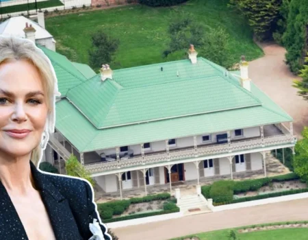 Aerial view of Nicole Kidman House, showcasing the grand Australian farmhouse with a green roof, wraparound verandas, and lush landscaped grounds.