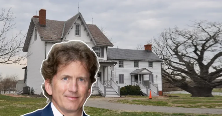 Todd Howard House, a historic white farmhouse with steep gable roof and brick chimneys, surrounded by trees and open sky.