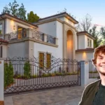 Front view of the Evan Peters House in Los Feliz, showing Mediterranean villa style, lush gardens, and luxury features.