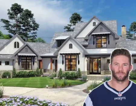 A stylish exterior shot of the Julian Edelman House, showcasing its colonial-modern design and lush Foxborough surroundings.