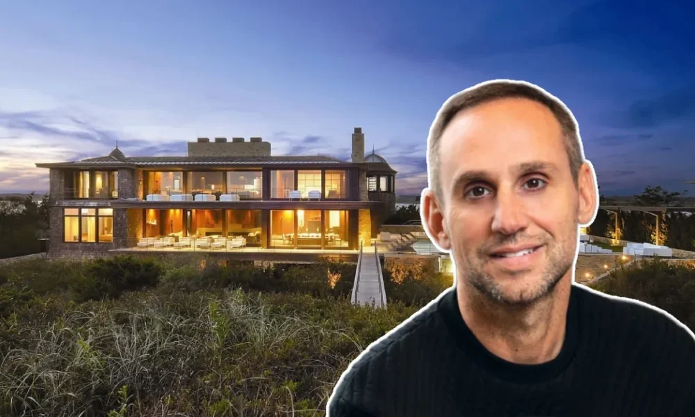 Michael Rubin House at sunset showcasing his sleek Hamptons estate with glowing interiors and oceanfront views.