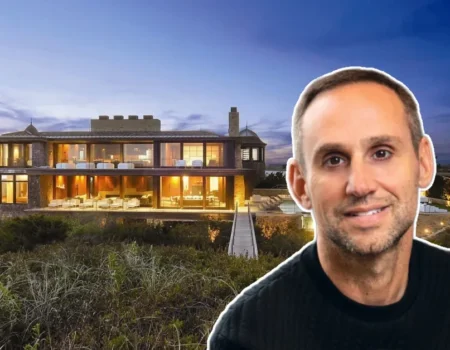 Michael Rubin House at sunset showcasing his sleek Hamptons estate with glowing interiors and oceanfront views.