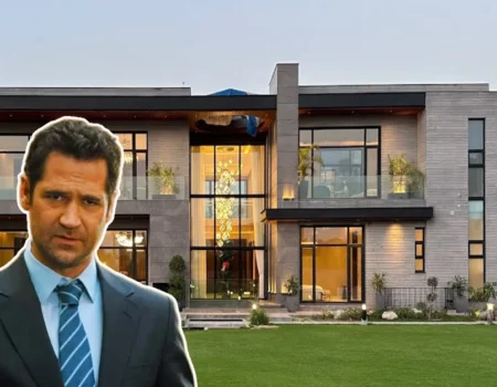 Mickey Haller stands in front of a sleek, modern mansion—perfectly capturing the luxury and power of the Mickey Haller House.