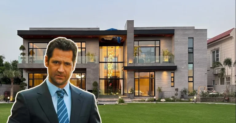 Mickey Haller stands in front of a sleek, modern mansion—perfectly capturing the luxury and power of the Mickey Haller House.