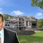 Front view of the Vince McMahon House, a grand Connecticut mansion surrounded by lush grounds and elegant landscaping.