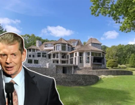 Front view of the Vince McMahon House, a grand Connecticut mansion surrounded by lush grounds and elegant landscaping.