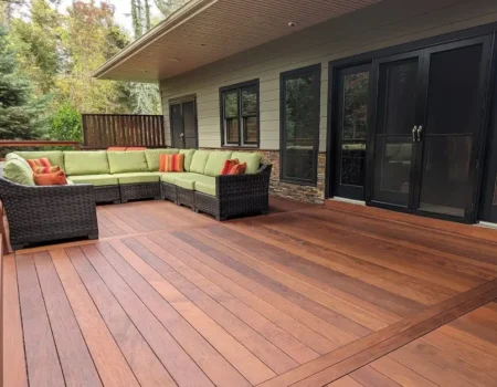 Modern backyard fence and deck with composite materials offering eco-friendly durability and stylish design.