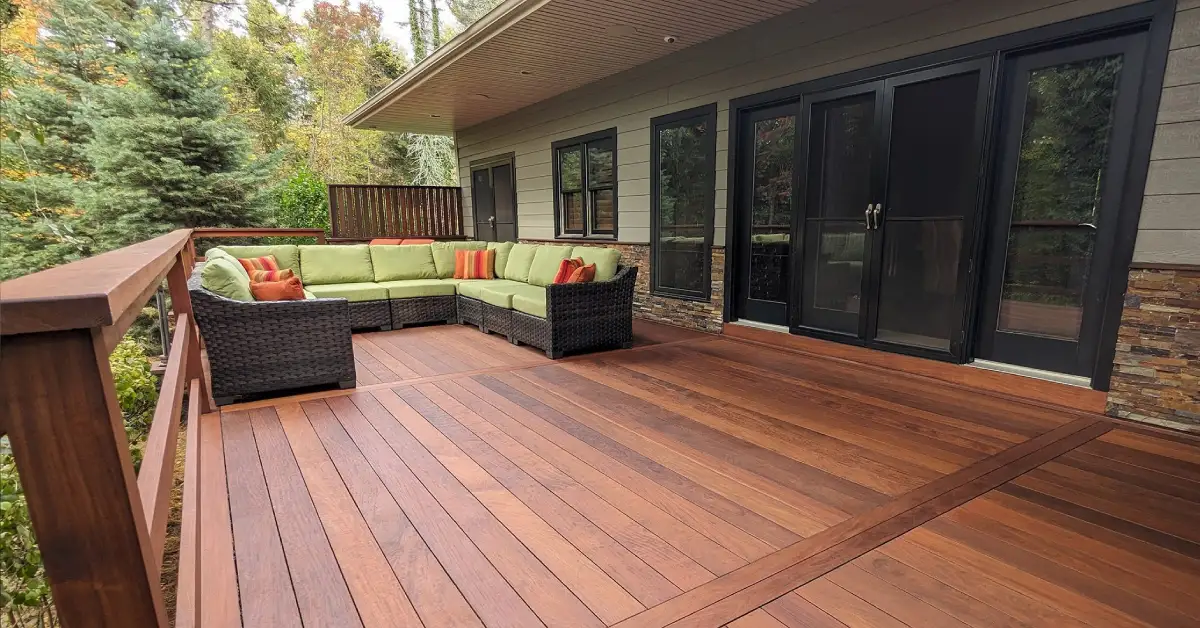 Modern backyard fence and deck with composite materials offering eco-friendly durability and stylish design.