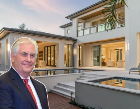 Portrait of Rex Tillerson in a formal suit with luxury homes in the background.