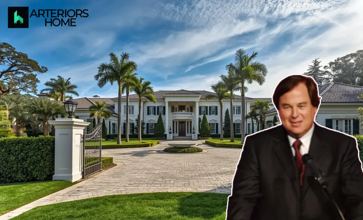 Aerial view of an elegant Beverly Hills mansion with lush gardens and driveway, located on North Rexford Drive.