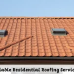 Residential roofing on a modern home with asphalt shingles and clean gutters