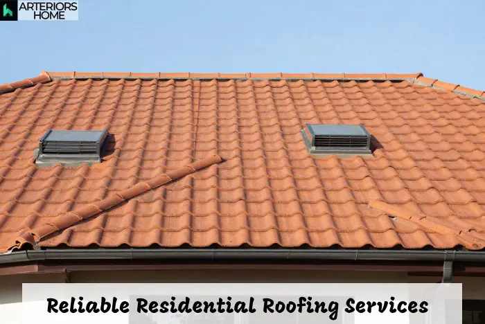 Residential roofing on a modern home with asphalt shingles and clean gutters