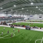 Apex Field House indoor turf fields with soccer and lacrosse action