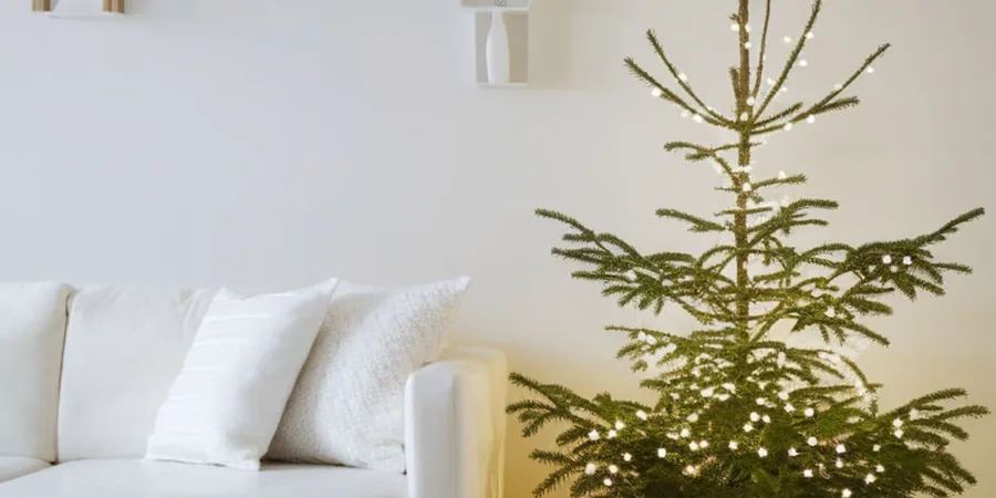 Scandinavian christmas decor ideas with a white tree, paper stars and pale wood