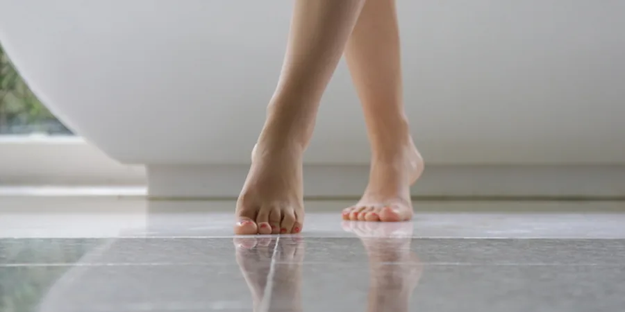 underfloor heating pros and cons: warm tiled bathroom with underfloor heating