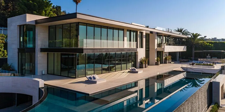 rihanna house living room with black marble fireplace and glass doors